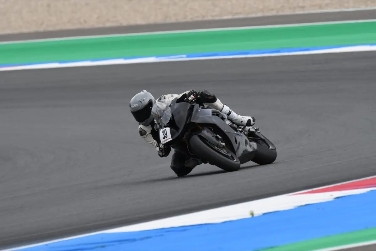 Motorcycle racer leaning through a fast corner on a race circuit